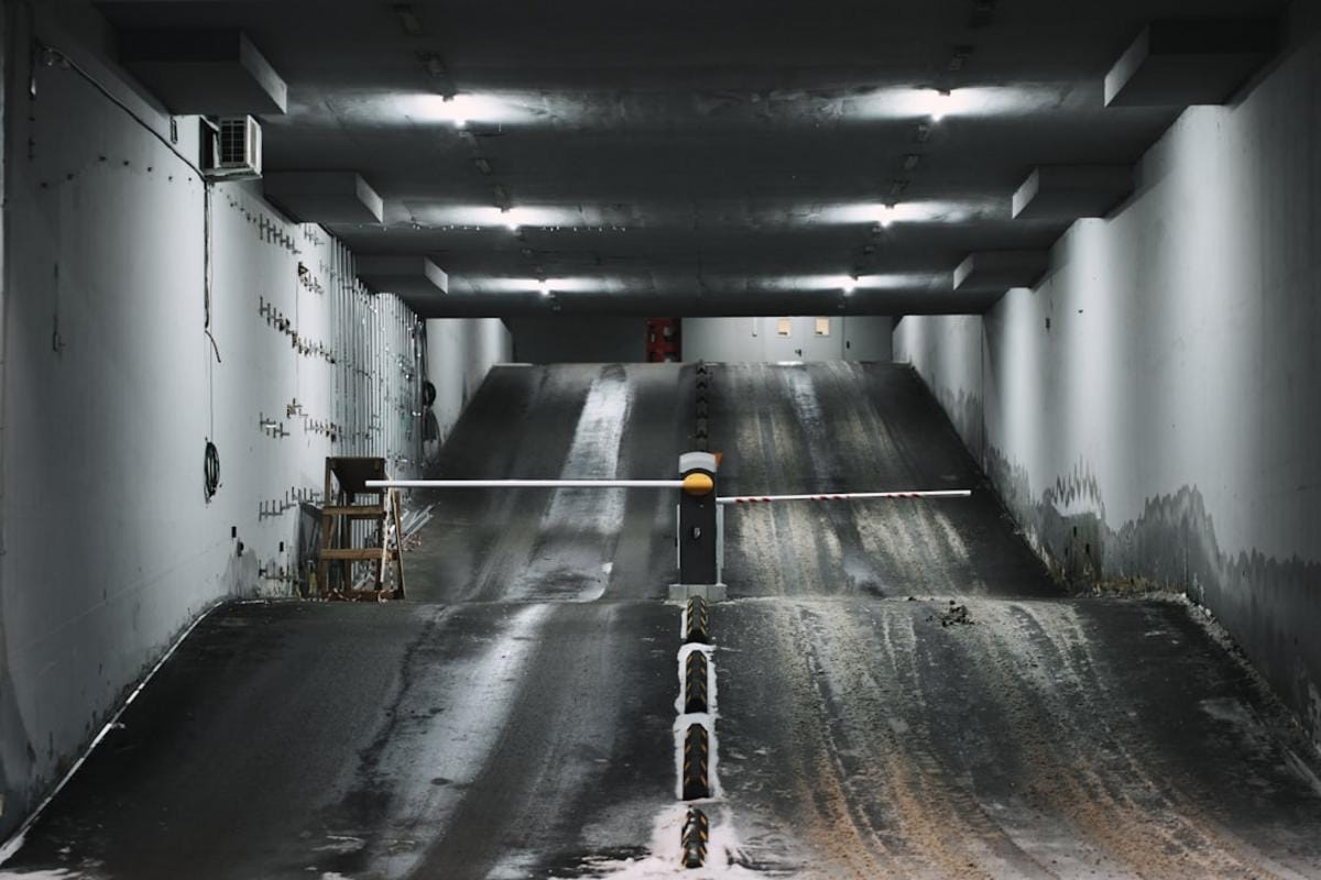 Close-up of a modern, automated concrete batching plant with digital control panels and mixing drums in operation