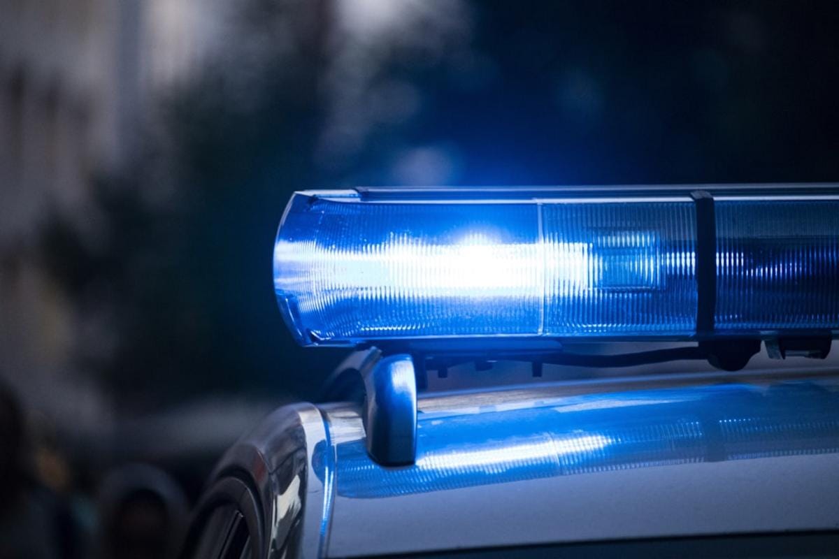 police compliance checks image prompt: police officers conducting compliance checks at a local business in Riverhead amid community safety efforts